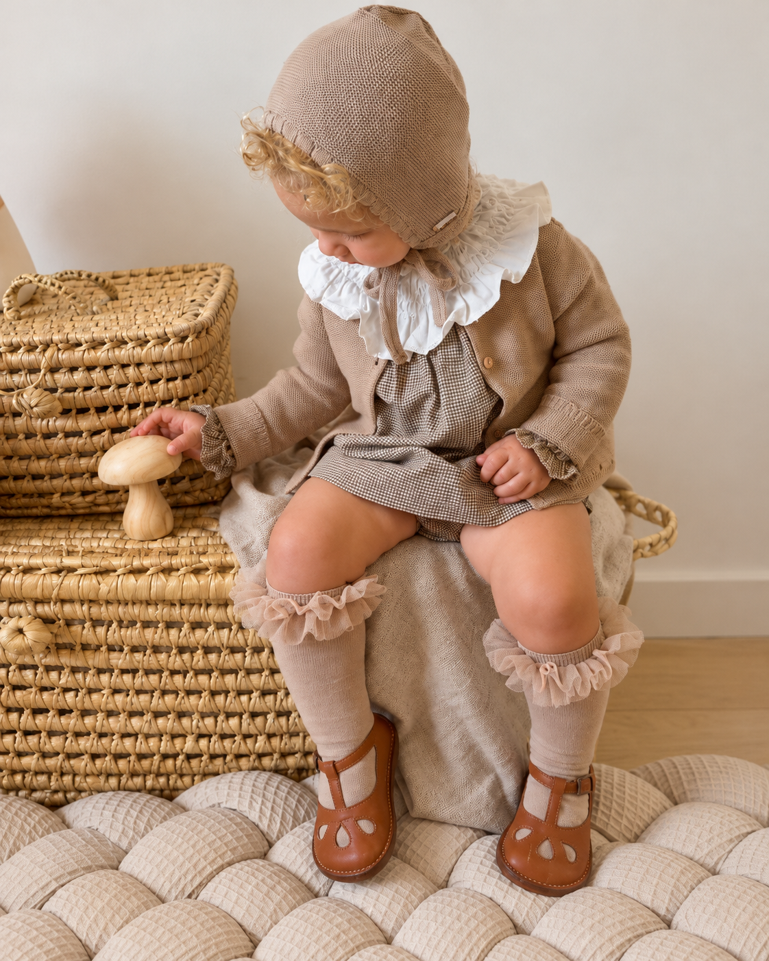 Niña con conjunto de punto, capota y calcetines con volante