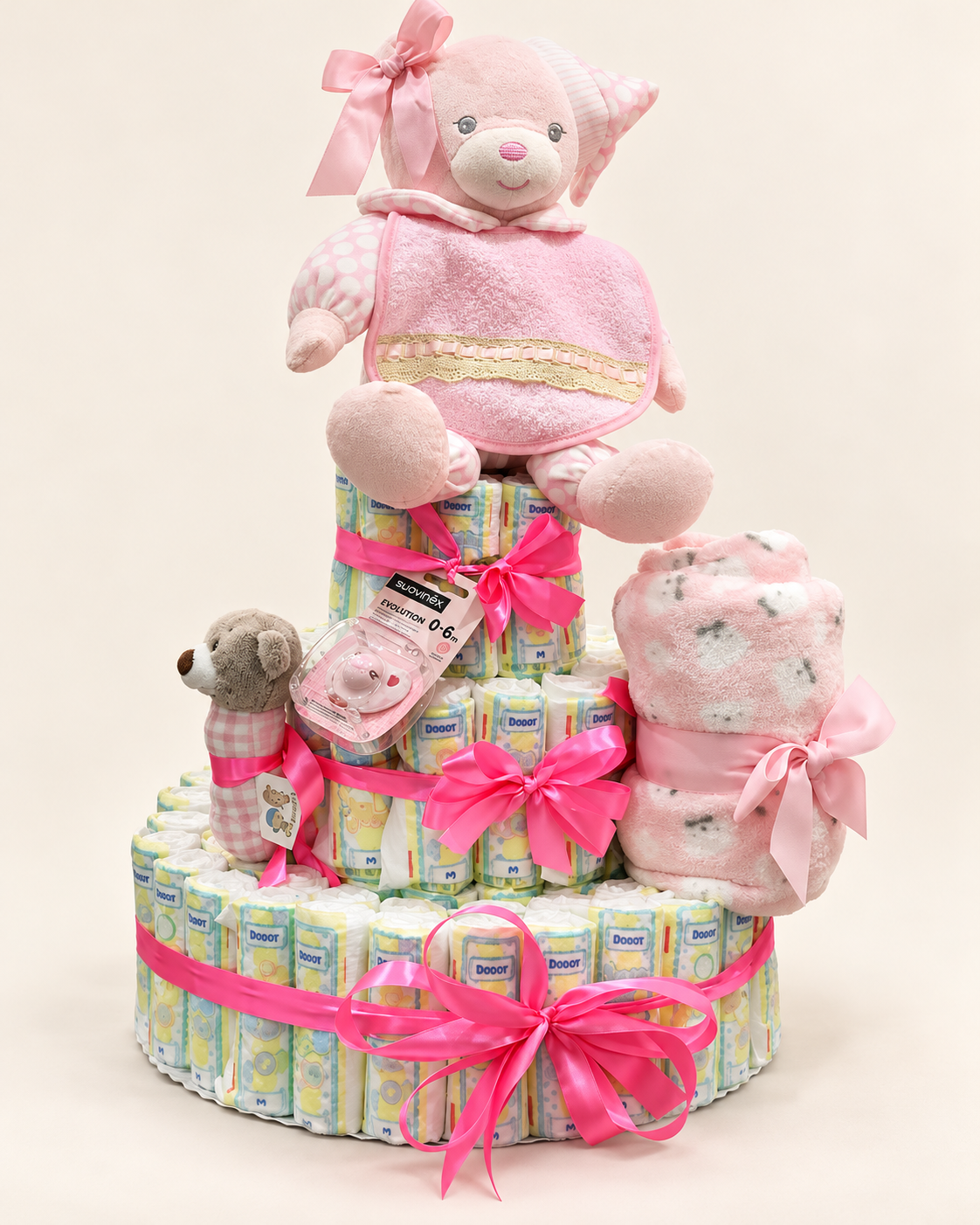 Tarta de pañales rosa con peluche, chupete y manta
